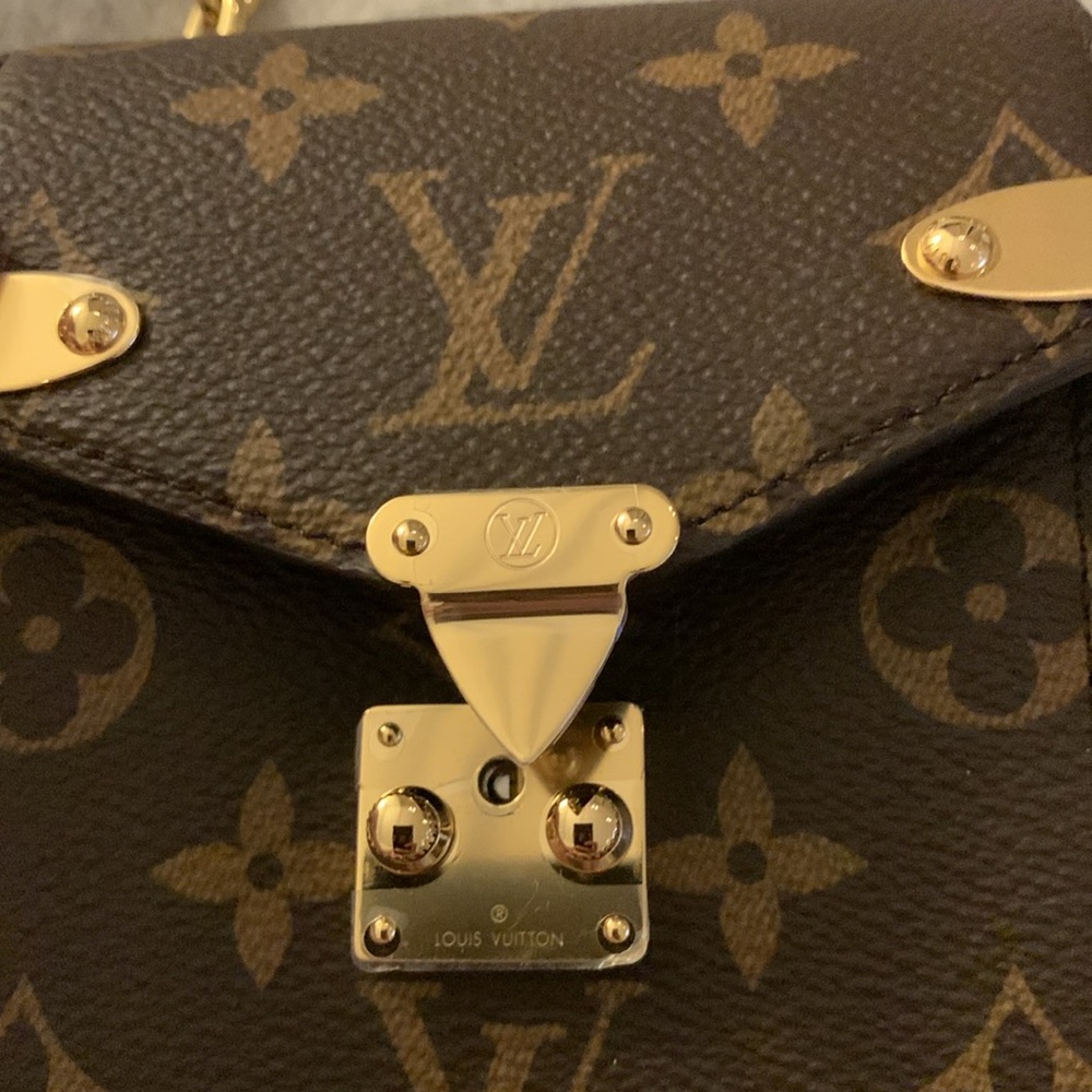 Rare Louis Vuitton monogram authentic new collection small purse w/golden chain.